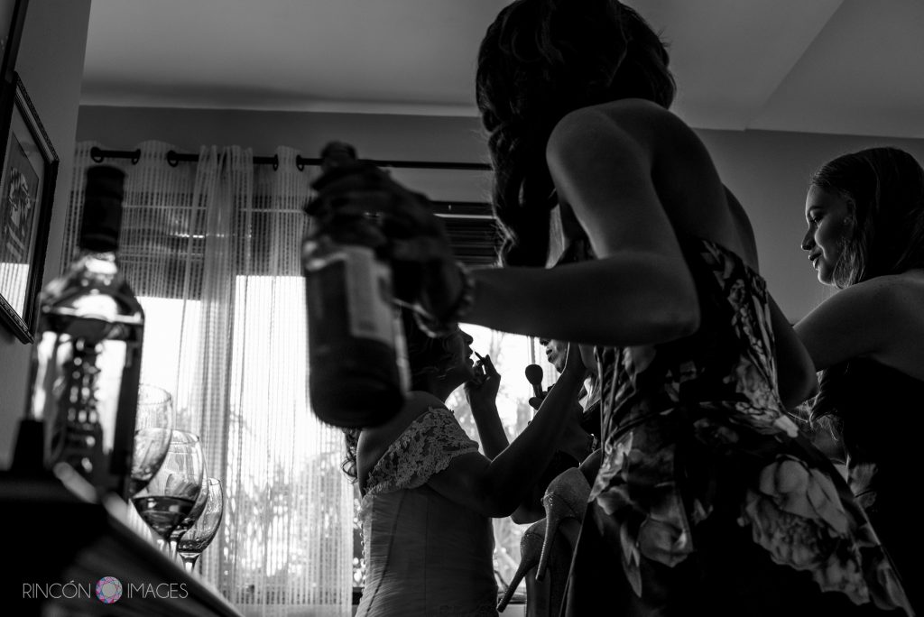 Black and white photo of a bride getting her make up done.
