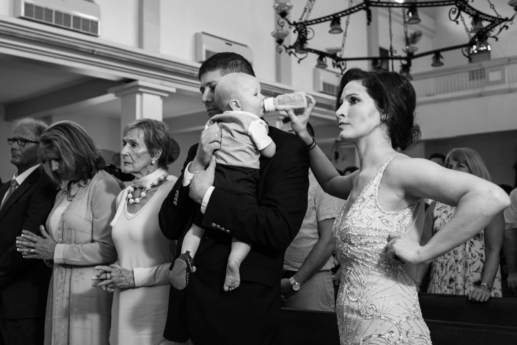 Mother feeding her baby during a wedding ceremony in Rincon, Puerto Rico.