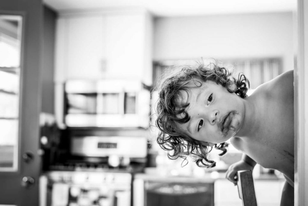 Wedding photograph of a child looking around the corner.