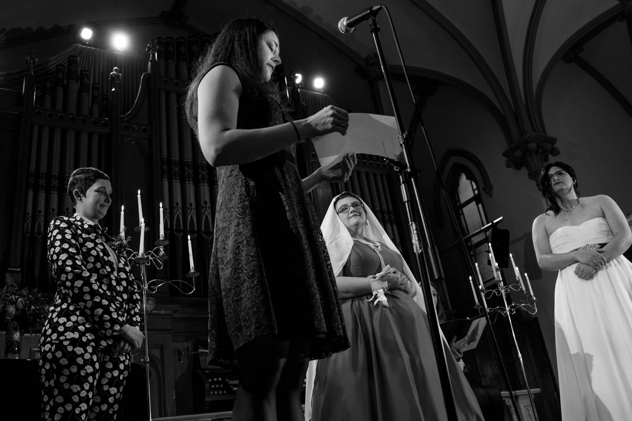Black and white photograph taken during wedding ceremony