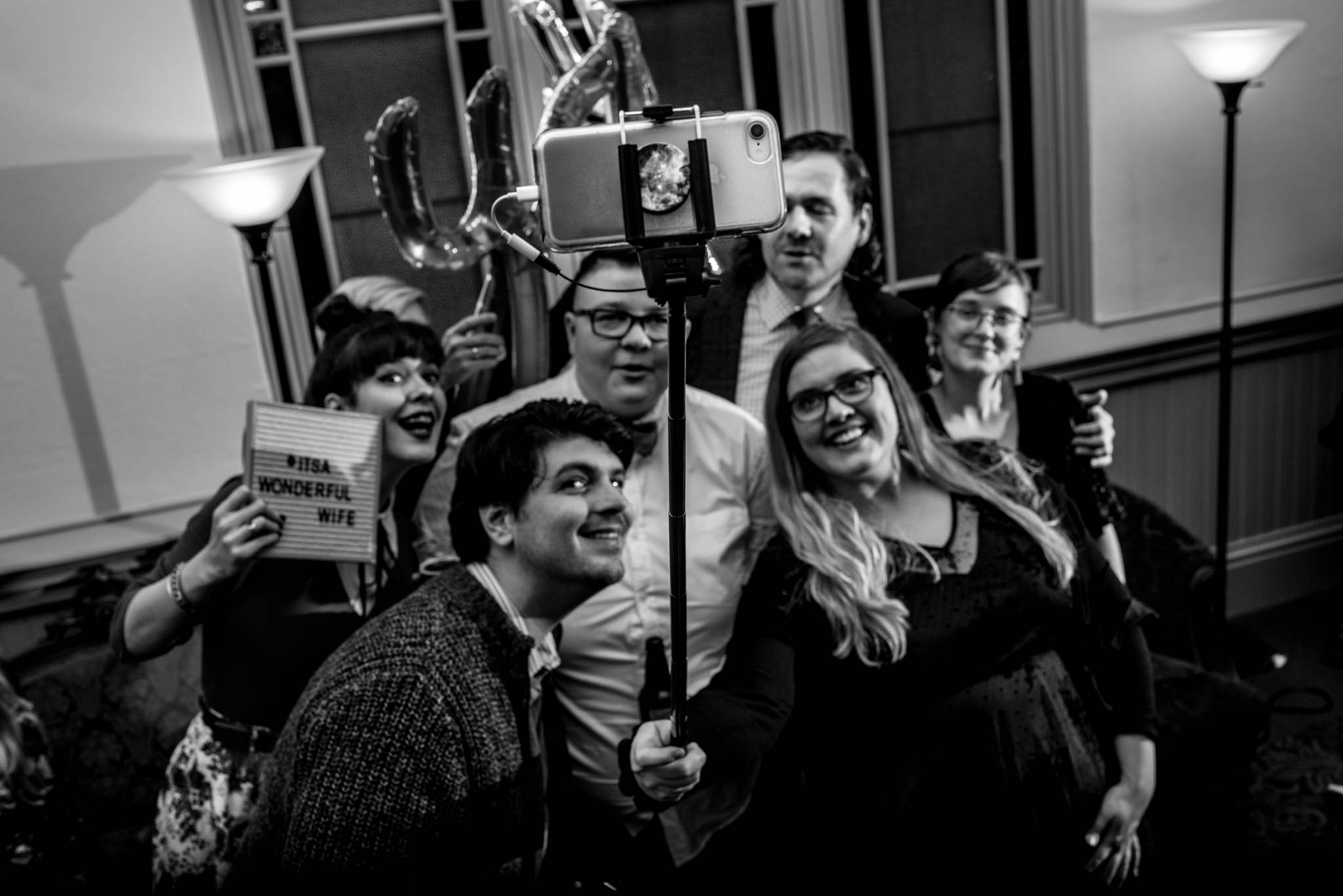 Wedding guests taking selfie with iphone