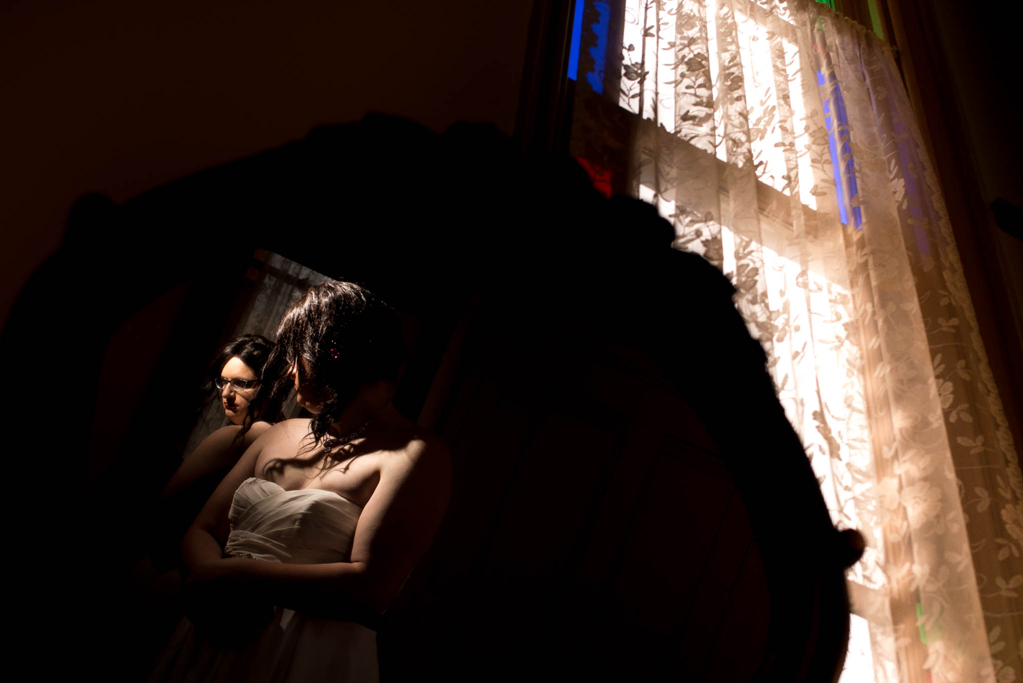 Bride getting ready in front of mirror