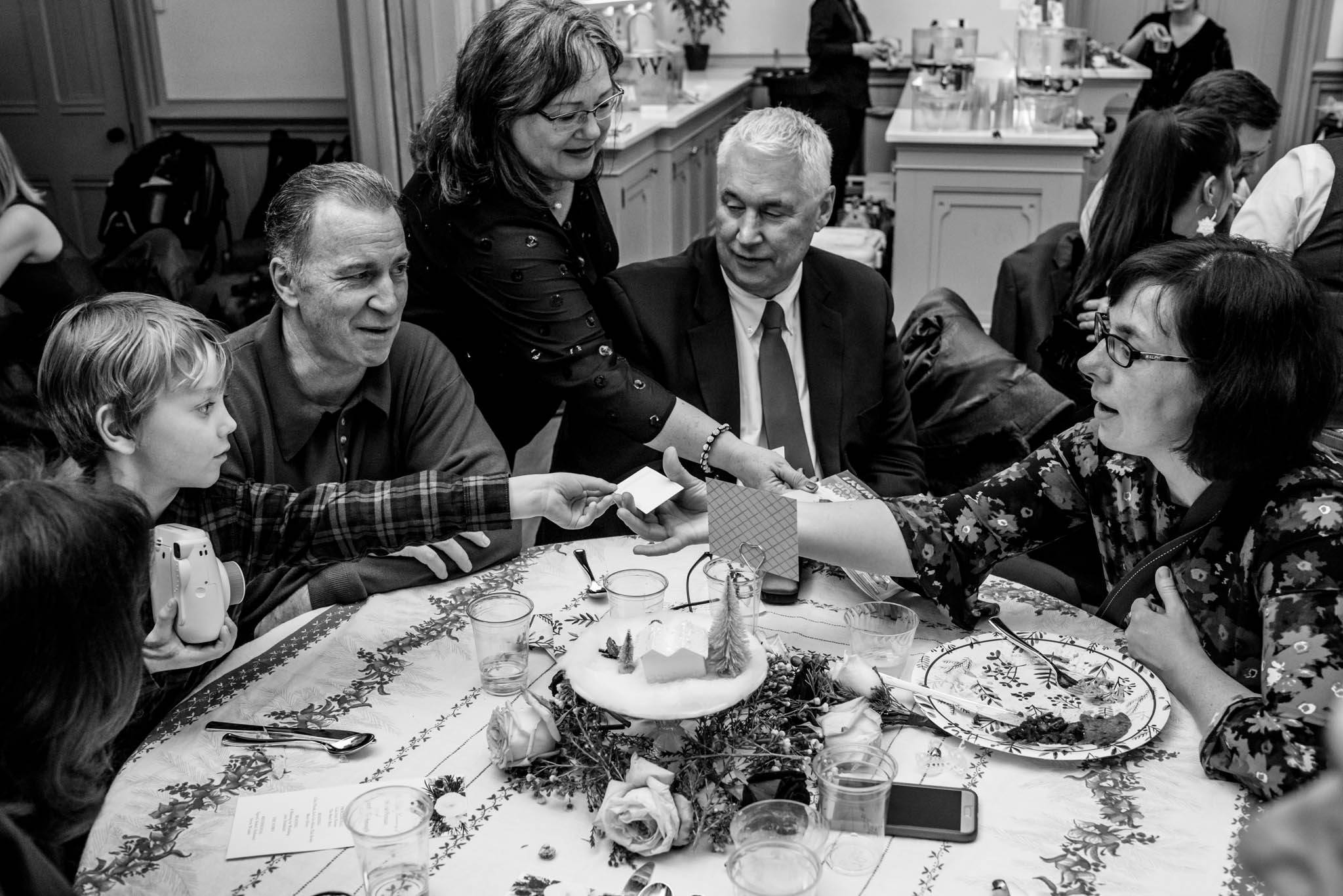 Candid photograph of wedding guests eating dinner