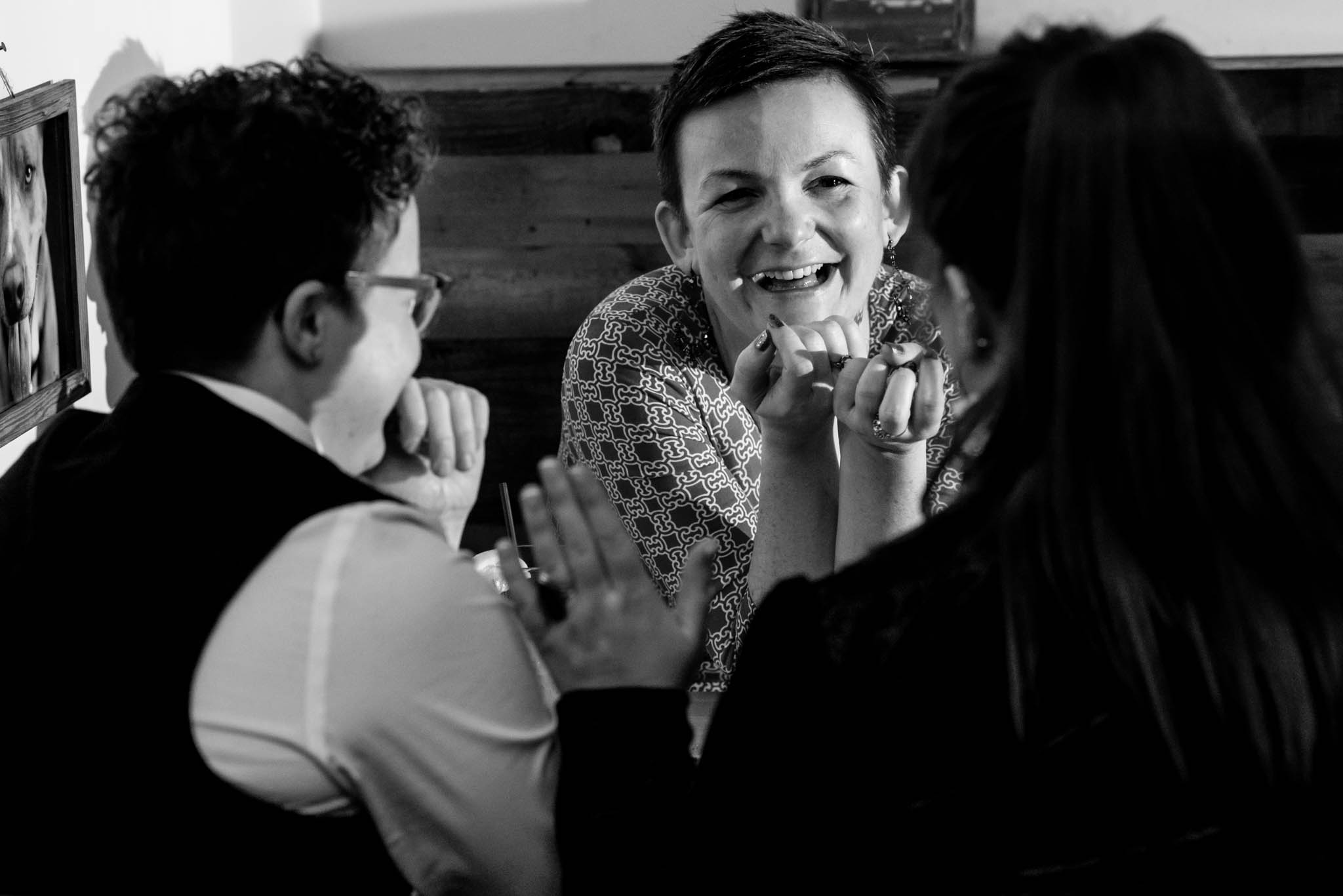 Wedding guests sitting at dinner table talking