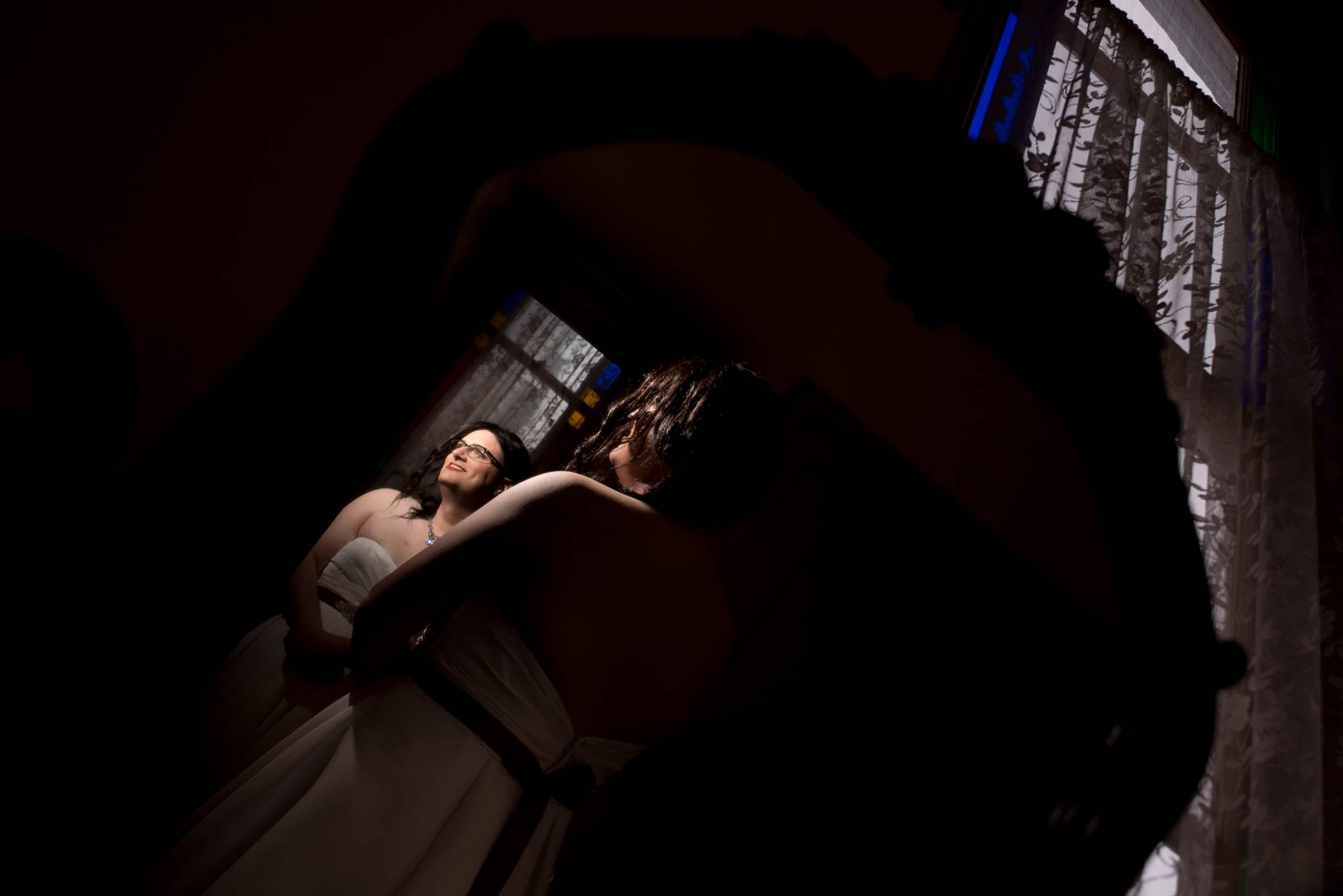 Bride getting ready by stained glass window in The Old Church