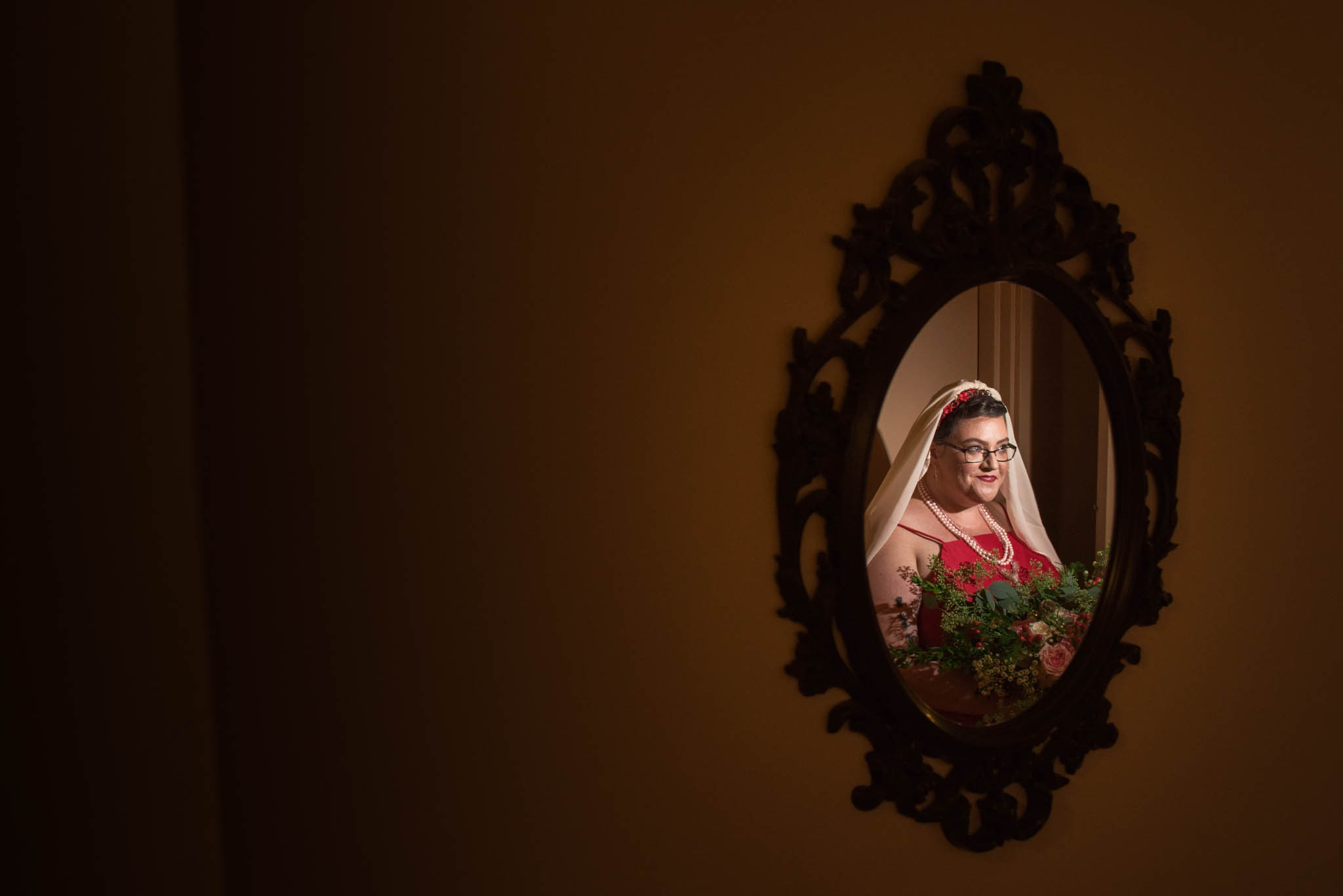 Portrait of a bride wearing red in a mirror