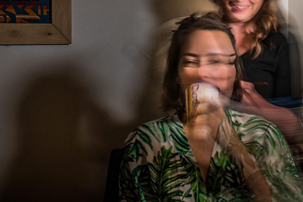 Motion blur photograph of a bride having her hair done on wedding day.