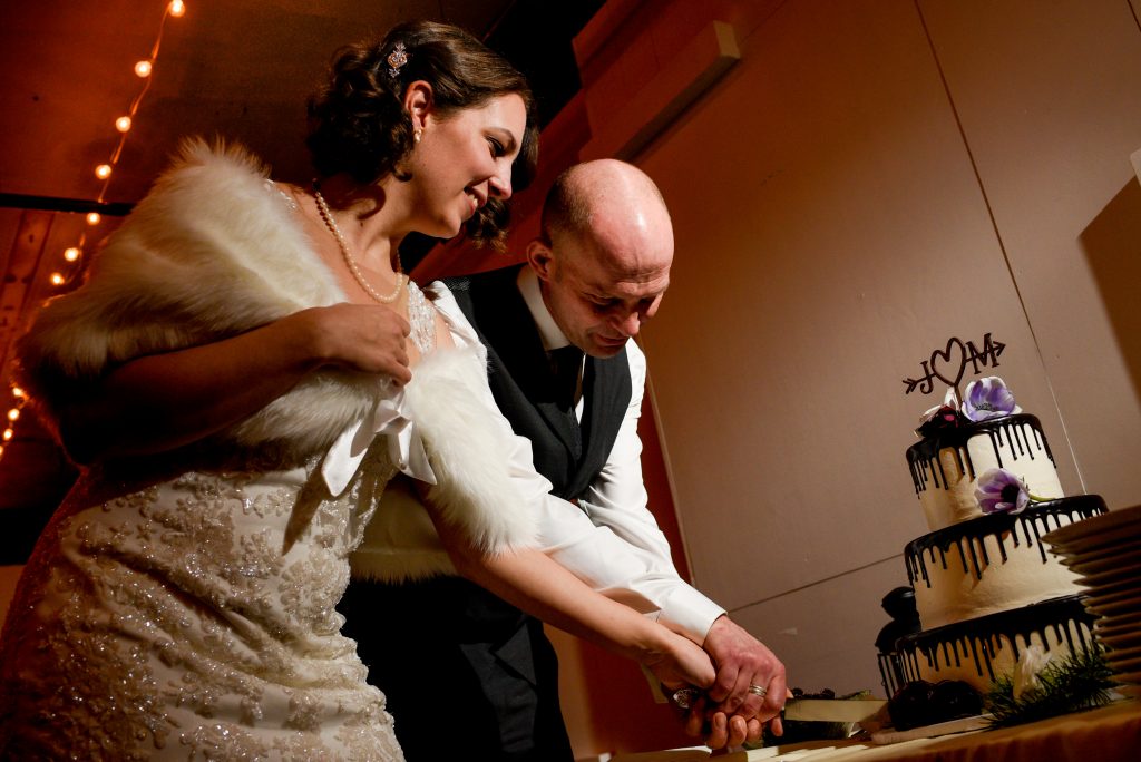 Bride and groom cutting their wedding cake.