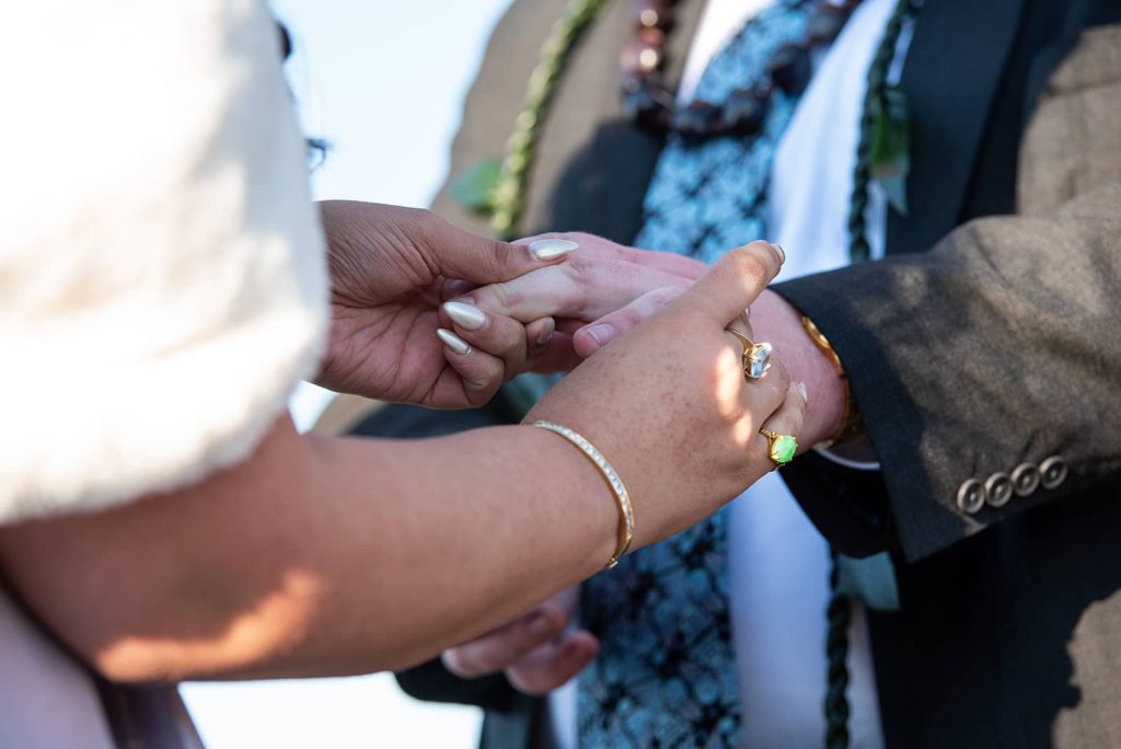 During the ceremony, the bride places the wedding ring on her groom's finger at The Maritime Memorial Park.