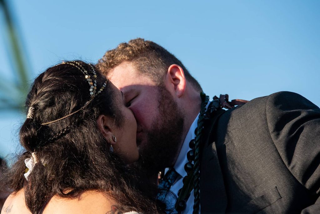 Picture of bride and groom share a kiss at The Maritime Memorial Park.