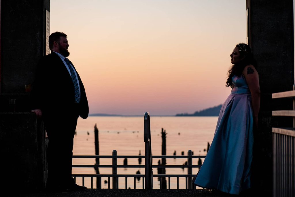 The bride and groom on the dock gazing into each other's eyes at sunset in The Maritime Memorial Park before heading to the Loft at The Red Building