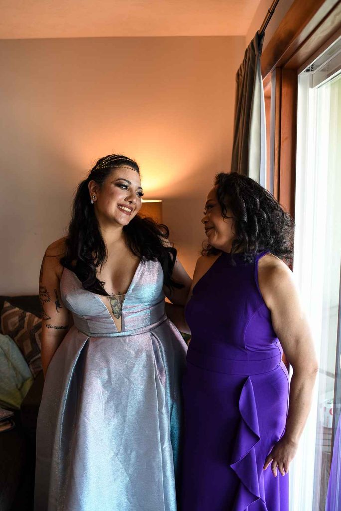the bride smiling at her mother while getting ready at the Astoria Inn.