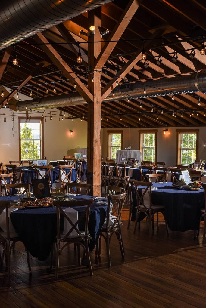 Picture of a table setting at the reception with navy blue tablecloths and finger food for the guest near the head table at The Loft at The Red Building in Astoria, Oregon