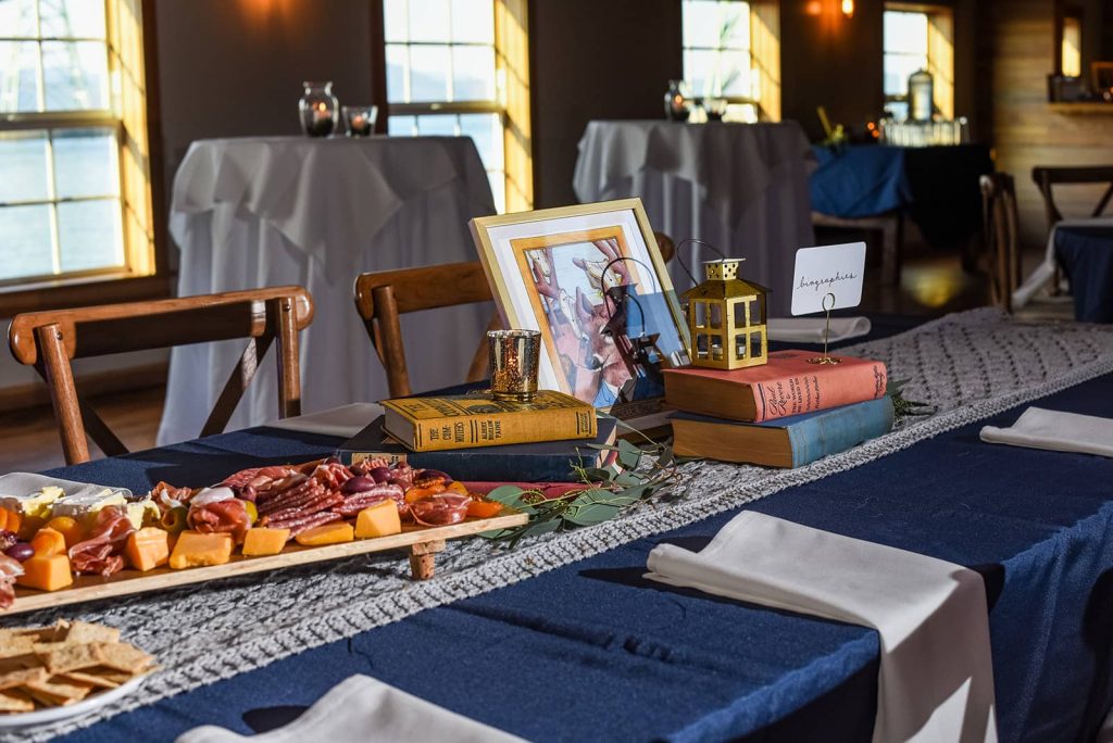 Picture of a table setting at the reception with meat, cheese, crackers and vintage books for decor at The Loft at The Red Building in Astoria, Oregon.
