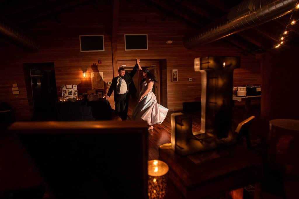 The capture of the newlywed's entrance into their reception. The groom twirls his bride at the reception.