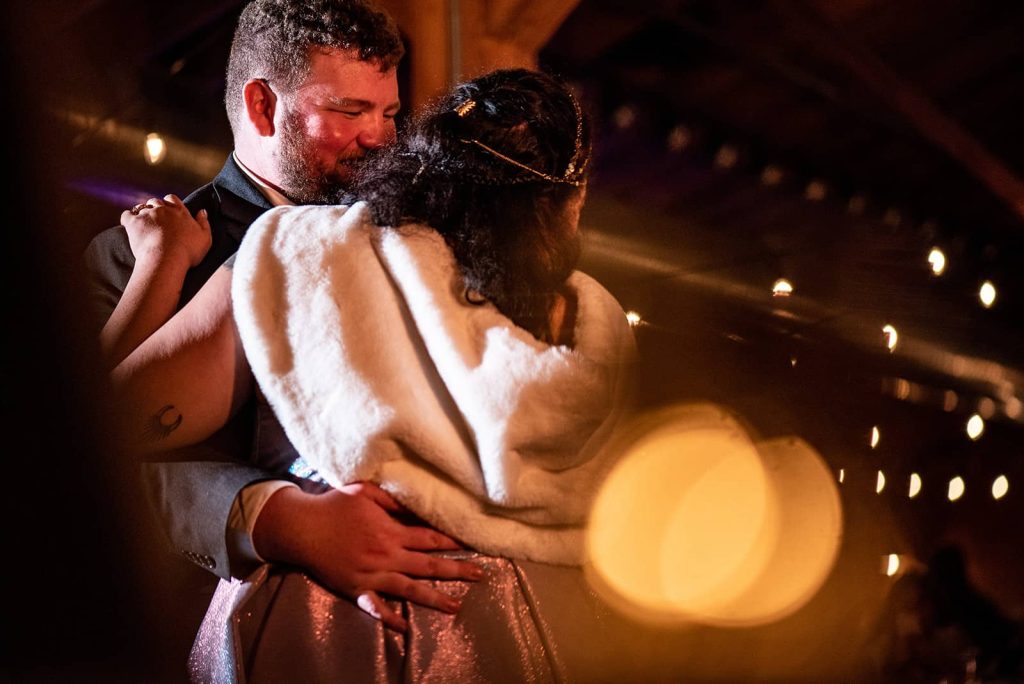 The happily newlyweds are enjoying a romantic moment in each other's arms at the reception at The Loft at The Red Building in Astoria, Oregon.