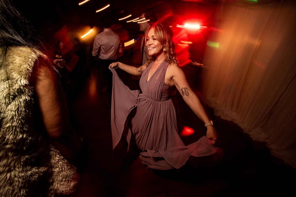 Stylized photo of wedding guests dancing at their reception at The Loft at The Loft at The Red Building in Astoria, Oregon.