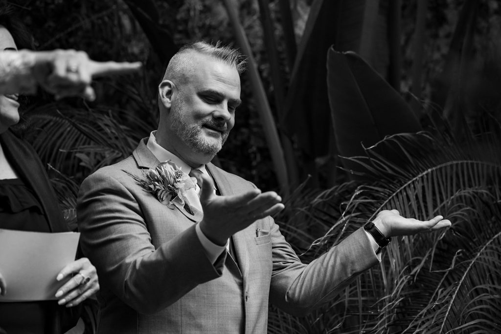 a man in a suit standing next to another man in a suit.