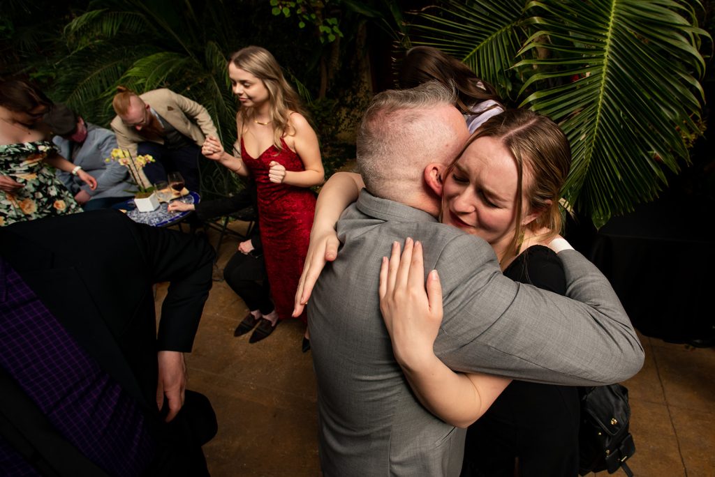 a man hugging a woman on the dance floor.