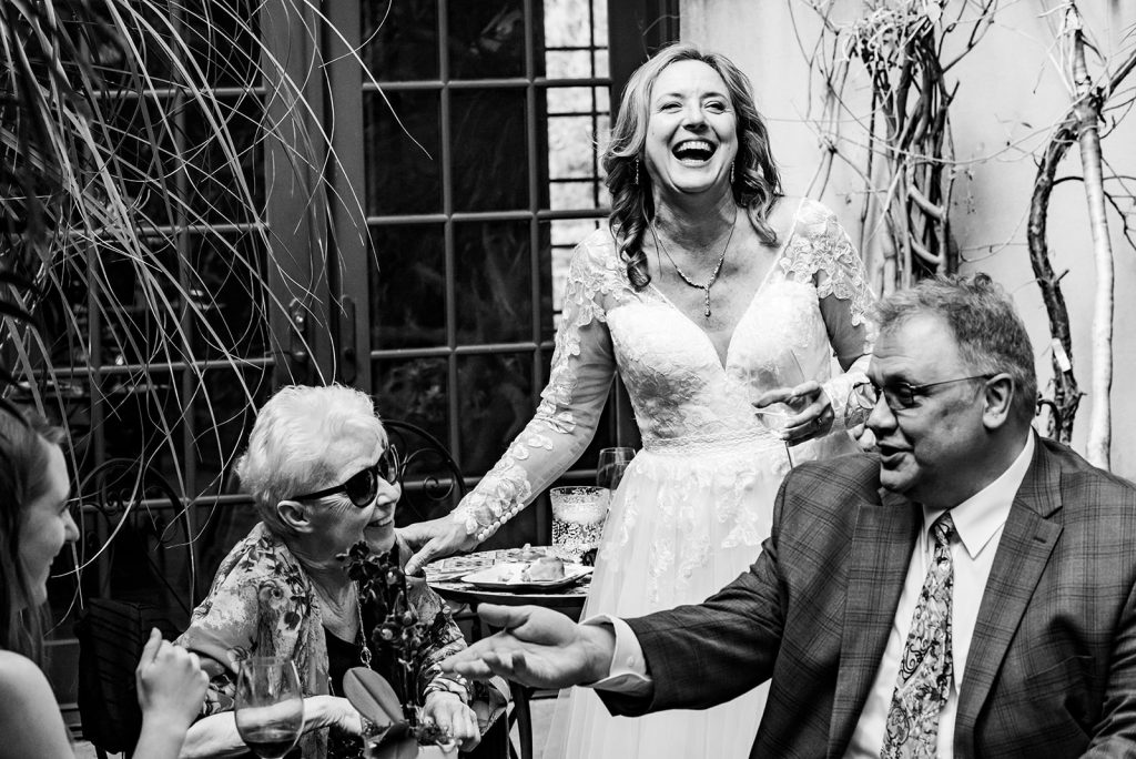 a woman in a wedding dress laughing. At Catalina Winery