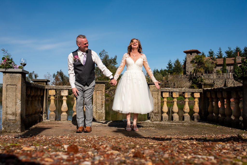 a bride and groom holding hands and walking.