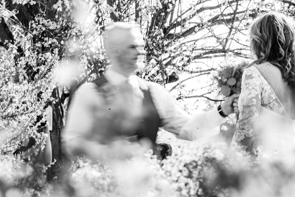 a man and a woman walking through a forest.