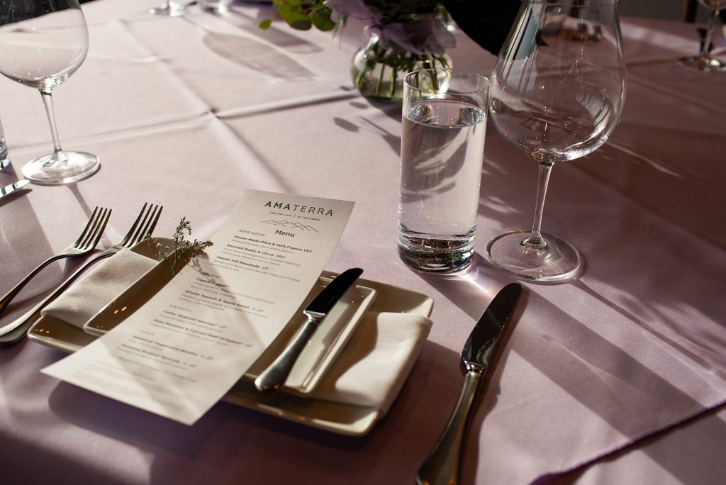 a table set with silverware and a menu.
