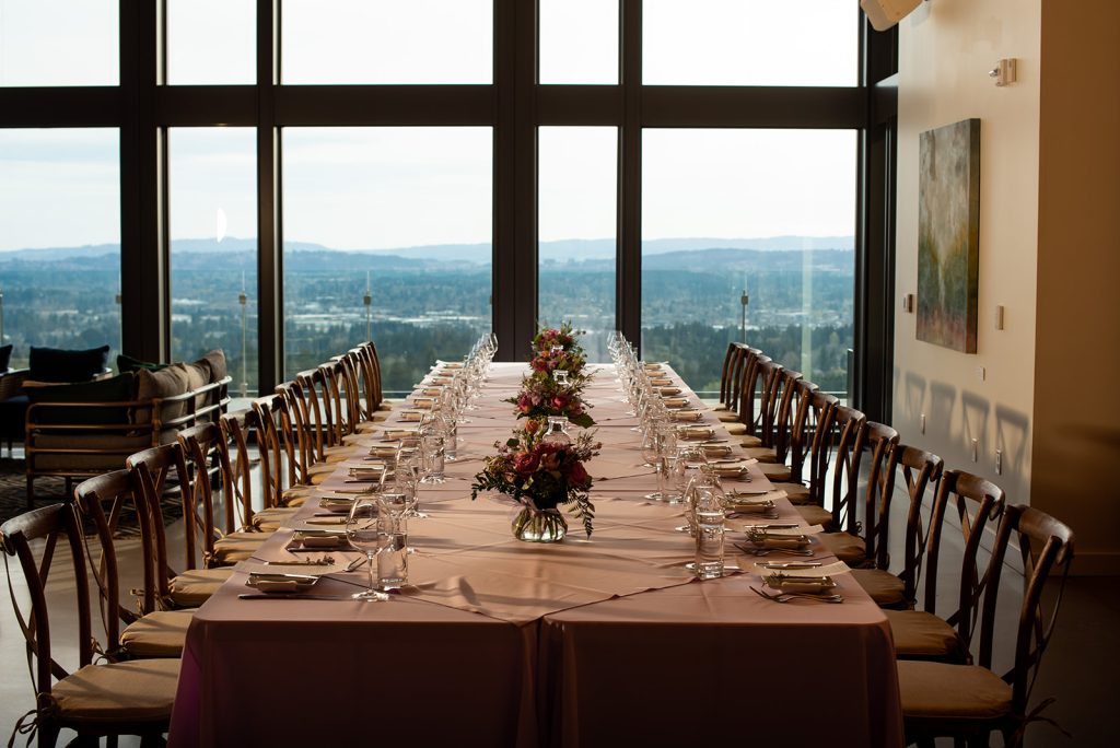 a long table with a vase of flowers on top of it.