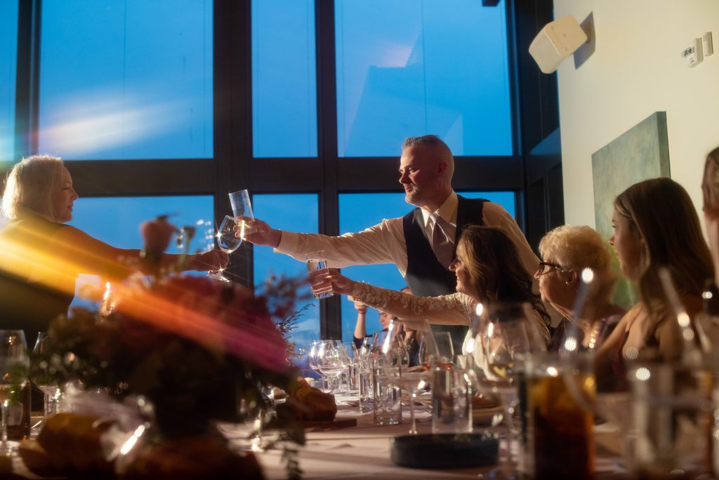 a group of people sitting around a table with wine glasses.
