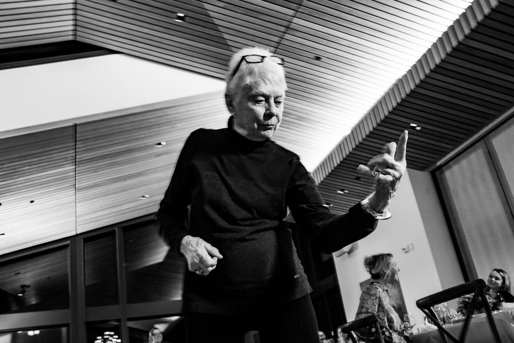a woman standing in a room at a wedding in Portland Oregon