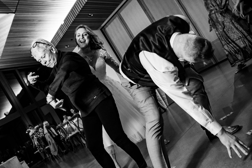 a couple of people that are standing up dancing at a wedding reception