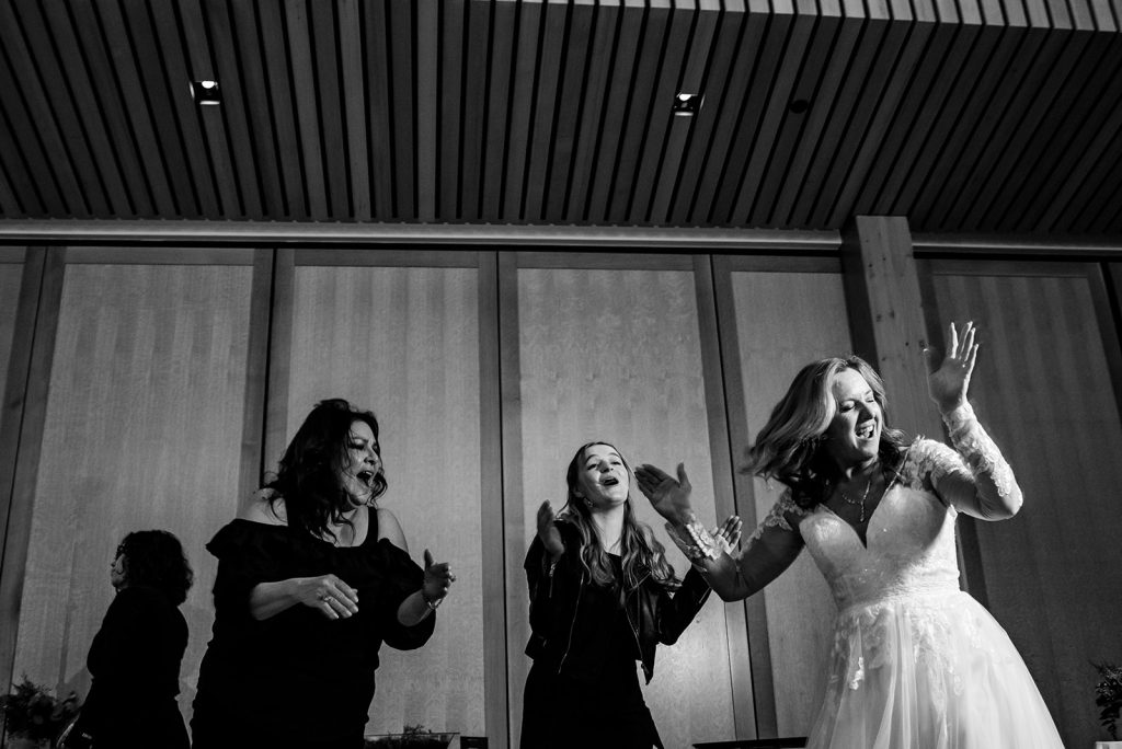 a group of women standing next to each other at a wedding